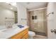 Modern bathroom featuring a glass-enclosed shower, updated fixtures, and wood-look tile at 3619 E Marmora St, Phoenix, AZ 85032