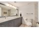 Bathroom featuring a double vanity, marble counters and updated fixtures at 3619 E Marmora St, Phoenix, AZ 85032