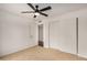 Bright bedroom featuring neutral carpet, ceiling fan, and a closet at 3619 E Marmora St, Phoenix, AZ 85032