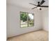 Bright bedroom featuring neutral carpet, ceiling fan, and a large window at 3619 E Marmora St, Phoenix, AZ 85032