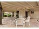 The covered patio features a concrete floor, and a table with 4 chairs at 3619 E Marmora St, Phoenix, AZ 85032