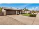 Inviting single-story home showcasing a well-kept lawn, desert landscaping, and an attached two-car garage at 3619 E Marmora St, Phoenix, AZ 85032