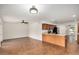 Open kitchen with wooden cabinets, stainless steel appliances, and easy access to multiple rooms at 3619 E Marmora St, Phoenix, AZ 85032