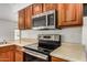 Modern kitchen featuring stainless steel appliances, and wood cabinets at 3619 E Marmora St, Phoenix, AZ 85032