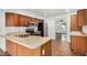 Traditional kitchen featuring wooden cabinetry, stainless steel appliances, and tiled floors at 3619 E Marmora St, Phoenix, AZ 85032