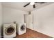 The laundry room features a ceiling fan, washer, dryer, tile flooring and white walls at 3619 E Marmora St, Phoenix, AZ 85032
