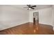 Open-concept living room with rich hardwood floors, a ceiling fan, and lots of natural light at 3619 E Marmora St, Phoenix, AZ 85032