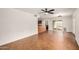 Large living room area with tiled flooring, fan and easy access to the kitchen at 3619 E Marmora St, Phoenix, AZ 85032