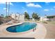 Community pool surrounded by green space and seating areas for relaxation at 3737 E Turney Ave # 206, Phoenix, AZ 85018