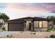 Charming single-story home with a two-car garage, neutral color palette, and desert landscaping at 39965 W Sparks Ln, Maricopa, AZ 85138