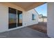 A covered patio with stucco walls, concrete floor and a view of the block wall enclosed yard at 39965 W Sparks Ln, Maricopa, AZ 85138