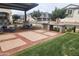Community outdoor barbecue area with picnic tables, a grill, and plenty of green space at 4063 E Amoroso Dr, Gilbert, AZ 85296