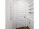 Hallway featuring white cabinets and shelves and exterior door at 4063 E Amoroso Dr, Gilbert, AZ 85296