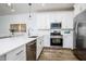 Stylish kitchen featuring white cabinetry, a stainless-steel oven, and quartz countertops at 4063 E Amoroso Dr, Gilbert, AZ 85296