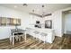 Bright, modern kitchen with white cabinets, quartz counters, and stainless appliances at 4063 E Amoroso Dr, Gilbert, AZ 85296