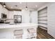 Eat-in kitchen with white cabinets and stainless-steel refrigerator at 4063 E Amoroso Dr, Gilbert, AZ 85296