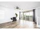 Modern living room featuring wood-look flooring and a sliding glass door at 4063 E Amoroso Dr, Gilbert, AZ 85296