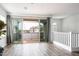 Bright living room featuring wood floors and sliding glass doors to outdoor balcony at 4063 E Amoroso Dr, Gilbert, AZ 85296