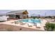 Community pool with lounge chairs, shade umbrellas, and adjacent recreation center at 4063 E Amoroso Dr, Gilbert, AZ 85296