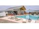 Resort-style community pool with poolside seating, shade umbrellas, and an adjacent recreation center at 4063 E Amoroso Dr, Gilbert, AZ 85296
