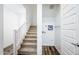 Staircase with carpet runner and a laundry room tucked under the stairs at 4063 E Amoroso Dr, Gilbert, AZ 85296