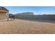 Large gravel backyard with a metal outdoor dining table, and views of the surrounding neighborhood at 4080 N 309Th Cir, Buckeye, AZ 85396