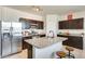 Modern kitchen with stainless steel appliances, granite countertops, and a large island with seating at 4080 N 309Th Cir, Buckeye, AZ 85396