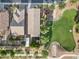 An aerial view shows the roof of a home next to a well-manicured green space with mature landscaping at 41138 N Soap Berry St, Queen Creek, AZ 85140
