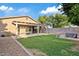 Spacious backyard features a covered patio, a green lawn, a seating area, and a block wall at 41138 N Soap Berry St, Queen Creek, AZ 85140
