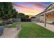 Lush backyard showcasing a well-manicured lawn, spacious storage, and charming patio area at 41138 N Soap Berry St, Queen Creek, AZ 85140