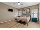 This bedroom is well lit with a bed and a mounted TV on the wall at 41138 N Soap Berry St, Queen Creek, AZ 85140