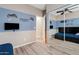 This bedroom with a ceiling fan also includes a gaming zone theme, a mirror, and wood-look floors at 41138 N Soap Berry St, Queen Creek, AZ 85140