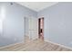 This empty bedroom features an open door into another room at 41138 N Soap Berry St, Queen Creek, AZ 85140