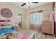 Bright bedroom features a ceiling fan, wood-look floors, and a theme at 41138 N Soap Berry St, Queen Creek, AZ 85140