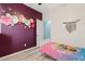 This bedroom features a unique flower design on the wall and a bed at 41138 N Soap Berry St, Queen Creek, AZ 85140