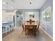 An eat-in dining area with a wood table and chairs, and views of the open-concept kitchen at 41138 N Soap Berry St, Queen Creek, AZ 85140