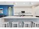 Open kitchen with a center island with barstool seating, pendant lights, and modern appliances at 41138 N Soap Berry St, Queen Creek, AZ 85140
