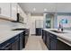 Gourmet kitchen featuring two-tone cabinets, stainless appliances, large island and marble backsplash at 41138 N Soap Berry St, Queen Creek, AZ 85140