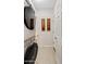 Bright laundry room with washer, dryer, neutral color walls, floral art and white paneled doors at 41138 N Soap Berry St, Queen Creek, AZ 85140