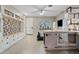 Bright living room featuring a large window, modern cabinets, dog kennel, and a mud room at 41138 N Soap Berry St, Queen Creek, AZ 85140