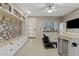 Bright living room featuring a large window, modern cabinets, dog kennel, and a mud room at 41138 N Soap Berry St, Queen Creek, AZ 85140