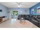 The living room has a comfortable leather sectional and sliding glass door to the backyard at 41138 N Soap Berry St, Queen Creek, AZ 85140