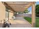 The covered patio features a concrete floor, string lights, and access to the backyard at 41138 N Soap Berry St, Queen Creek, AZ 85140