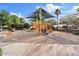 Community playground with slides, climbing structures, and shade, ideal for Gathering fun and recreation at 41138 N Soap Berry St, Queen Creek, AZ 85140