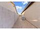 Small side yard with rock landscaping, cinder block wall and central air unit at 41138 N Soap Berry St, Queen Creek, AZ 85140