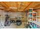 Unfinished storage room with open wood ceiling, block walls, and filled with various items for storage at 41138 N Soap Berry St, Queen Creek, AZ 85140