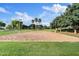Outdoor sand volleyball court surrounded by grass and mature trees in a community park at 41138 N Soap Berry St, Queen Creek, AZ 85140