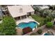 Aerial view of home with tile roof, backyard pool, covered patio, manicured lawn, and mature trees at 420 N Leoma Ln, Chandler, AZ 85225