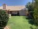 Private backyard with a well-maintained lawn, mature landscaping and covered patio at 420 N Leoma Ln, Chandler, AZ 85225