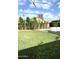 Expansive backyard with lush green grass, mature landscaping, and a refreshing in-ground pool, perfect for outdoor relaxation at 420 N Leoma Ln, Chandler, AZ 85225